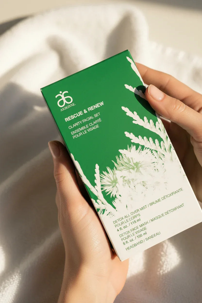 Arbonne Rescue and Renew Clarity Facial Set in-hand close-up soft towel background