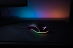 Altec Lansing GM300 black gaming mouse with rainbow RGB underglow and lit Altec Lansing X logo on dark mousepad in moody RGB gaming room