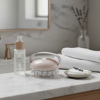 High-quality minimal skincare setup with ergonomic handheld body massage tool on white vanity marble surface