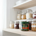 8Greens Daily Greens Peach Gummies jar in white kitchen health pantry on tiered shelf with clean-label whole-food jars