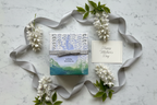 Thymes White Wisteria Candle premium gift flatlay on white marble with gift card and white flowers - More4less Outlet