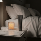 Lifestyle context image of Mary Kay TimeWise Age Minimize 3D Night Cream Combo/Oily (AI-generated for visual illustration only) – marble nightstand candlelight – More4less Outlet