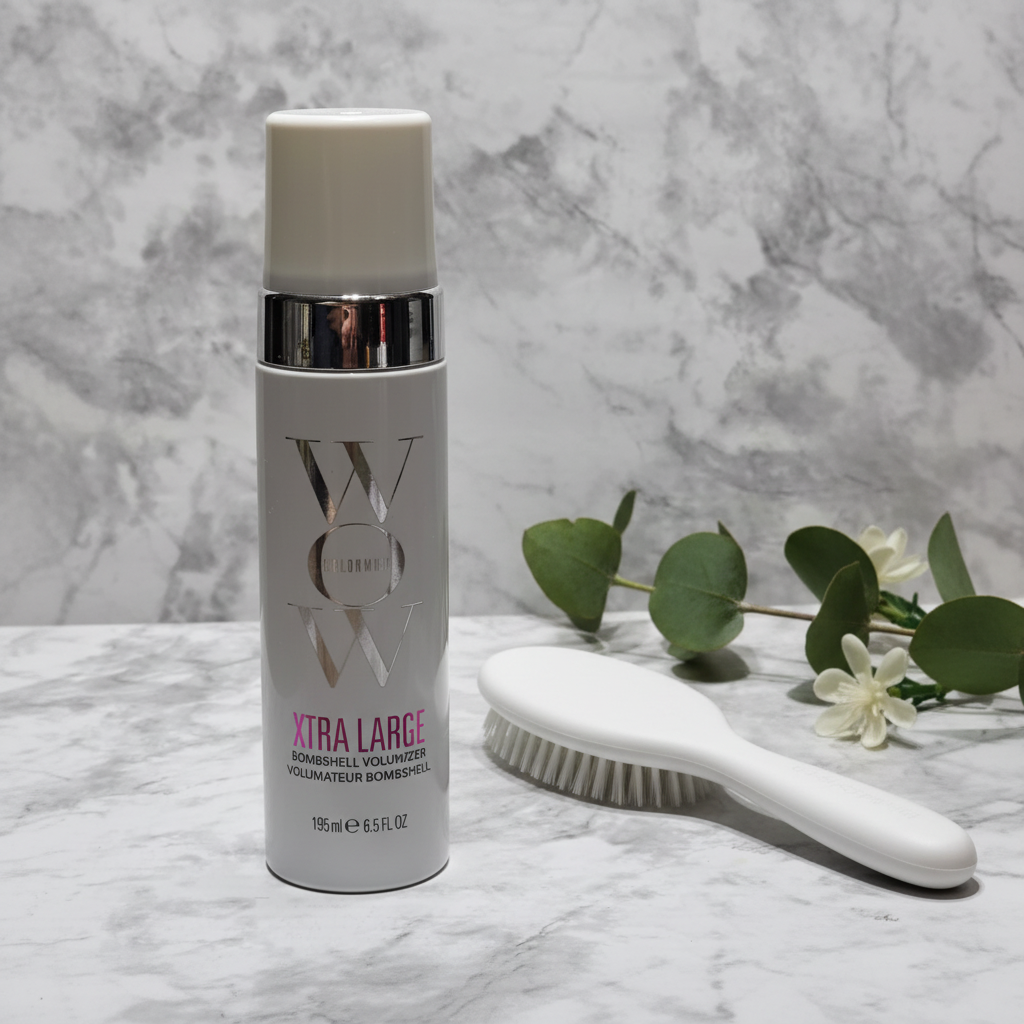 Color Wow Xtra Large Bombshell Volumizer white pump bottle on white marble beside styling brush and botanicals – More4less Outlet