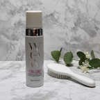 Color Wow Xtra Large Bombshell Volumizer white pump bottle on white marble beside styling brush and botanicals – More4less Outlet