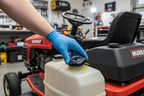 Gloved hand installing Stens 125-260 fuel cap with Kelch gauge onto Murray lawn tractor in garage - More4less Outlet