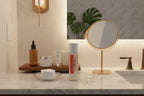 Minimalist master bathroom counter with Rodan + Fields eye makeup remover beside cotton pads and mirror