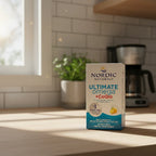 Soft natural light shining on high quality omega-3 CoQ10 supplement packaging box in clean home kitchen setting