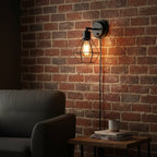 Globe Electric Evans matte black wire cage wall sconce in industrial home office
