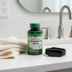 Nature's Truth L-Arginine HCl 1000mg bottle on white quartz bathroom vanity with organic cotton hand towel and black health tracker watch
