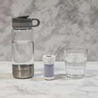 Contigo Clybourn replacement filter flat lay on white marble with water bottle and glass of fresh water