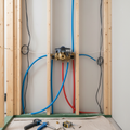 Grohe GrohSafe 3.0 shower rough-in valve installed inside a wall cavity with PEX expansion pipes during bathroom renovation.