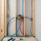 Grohe GrohSafe 3.0 shower rough-in valve installed inside a wall cavity with PEX expansion pipes during bathroom renovation.