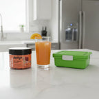 Chewsy Kids Multi jar on white quartz kitchen breakfast bar with orange juice and green lunchbox