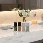 Mary Kay nail lacquer bottles on elegant marble vanity with jewelry tray, perfume, and fresh flowers.