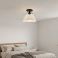 Avec Avery semi-flush mount matte black white shade installed in modern bedroom