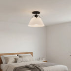 Avec Avery semi-flush mount matte black white shade installed in modern bedroom