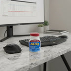 Aleve 220mg Naproxen Sodium 200ct bottle on granite home office desk with ergonomic mouse and keyboard