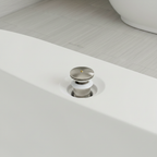 Close-up of American Standard satin nickel drain assembly at the base of a white freestanding bathtub drain opening