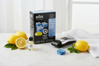 Premium men's grooming lifestyle flat lay featuring electric shaver maintenance supplies on white marble