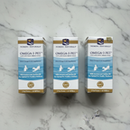 Three Nordic Naturals Omega-3 Pet supplement boxes arranged on white marble surface, 3-pack flat lay