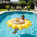 PoolCandy Sunflower Inflatable Pool Island floating in sunny backyard swimming pool person lounging