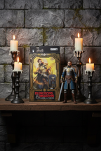 Hasbro Golden Archive D&D Xenk action figure displayed on dark fantasy shelf with candlelight dungeon backdrop — More4less Outlet