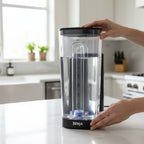 Ninja Thirsti 48oz reservoir being clicked into black Ninja Thirsti base system on bright kitchen counter for setup