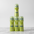 Four lime-green Ban Powder Fresh bottles stacked on marble