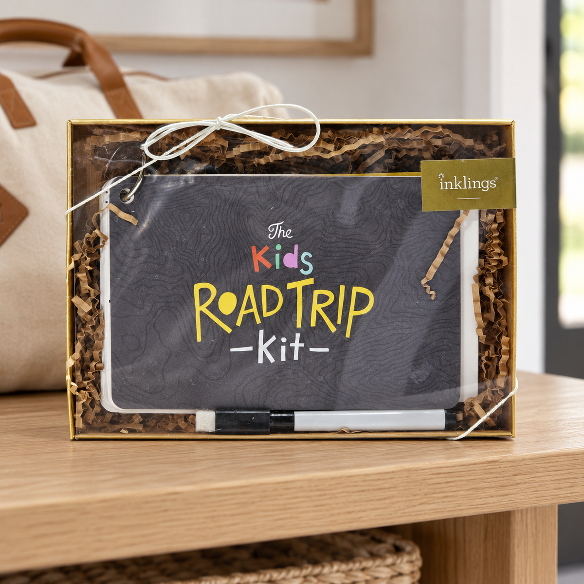 Inklings Paperie Kids Road Trip Kit box on an entryway packing bench