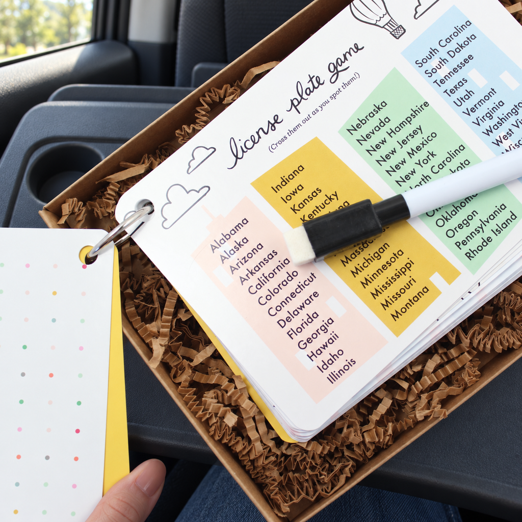 Inklings Road Trip Kit license-plate activity on a parked-car passenger tray