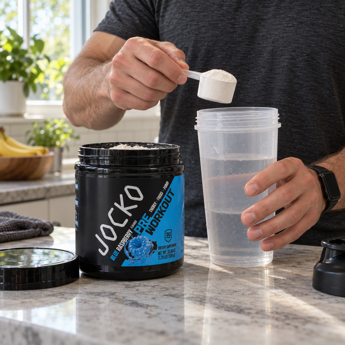 Preparing Jocko Blue Raspberry Pre-Workout in a shaker with water