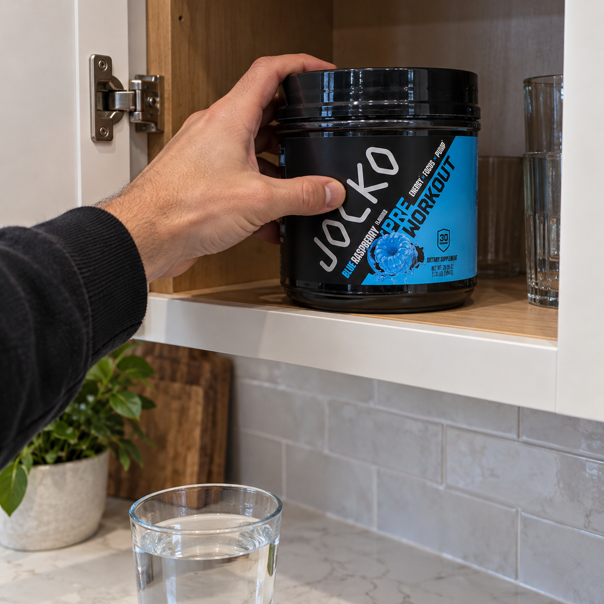 Putting a Jocko Blue Raspberry Pre-Workout tub in a cupboard
