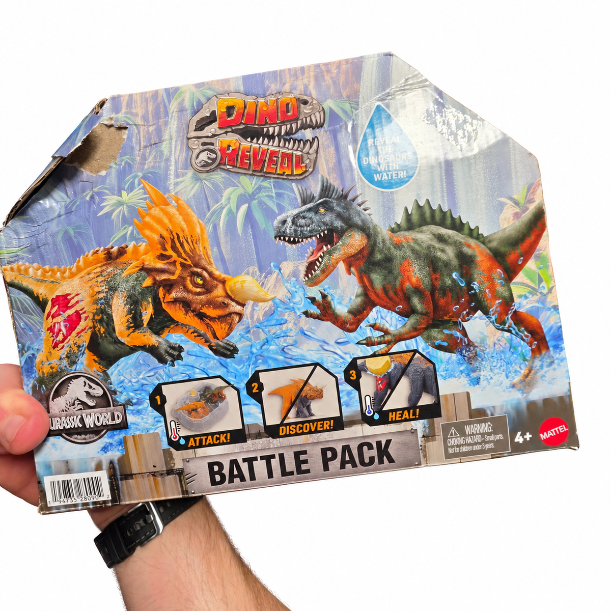 Jurassic World Dino Reveal Battle Pack package front with its torn upper-left corner and visible creases.