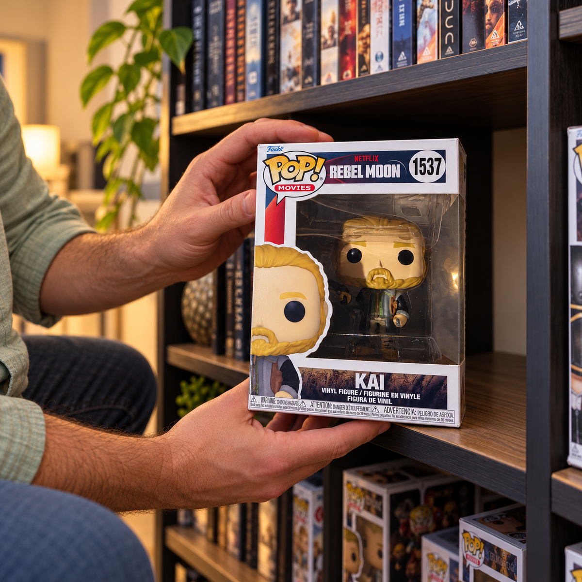 Boxed Funko Pop! Kai #1537 being placed on a display shelf.