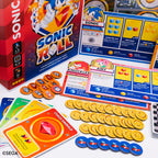 Product component image for KESS Sonic Roll board game showing the retail box, cards, tokens, and rulebook.