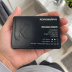 KEVIN.MURPHY ROUGH.RIDER 100 g closed case resting in an adult palm, with the front label visible.
