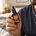 Holding the orange-label King C. Gillette Beard Oil bottle