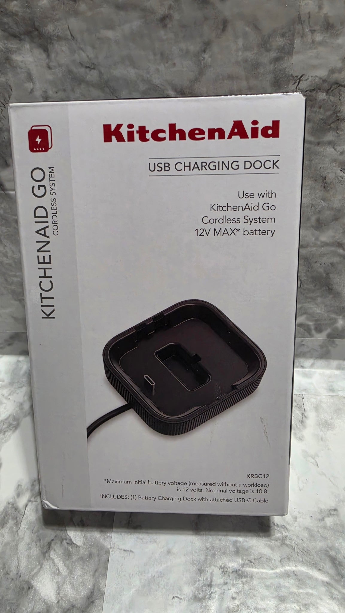 KitchenAid Go KRBC12 USB charging dock retail box front, showing the dock and attached cable