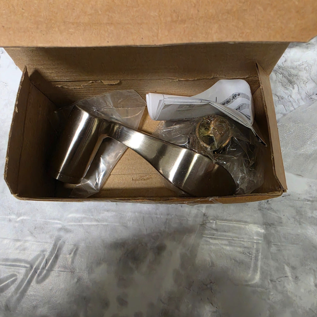 Actual satin nickel Layton left-hand dummy lever and original packaging, showing box wear