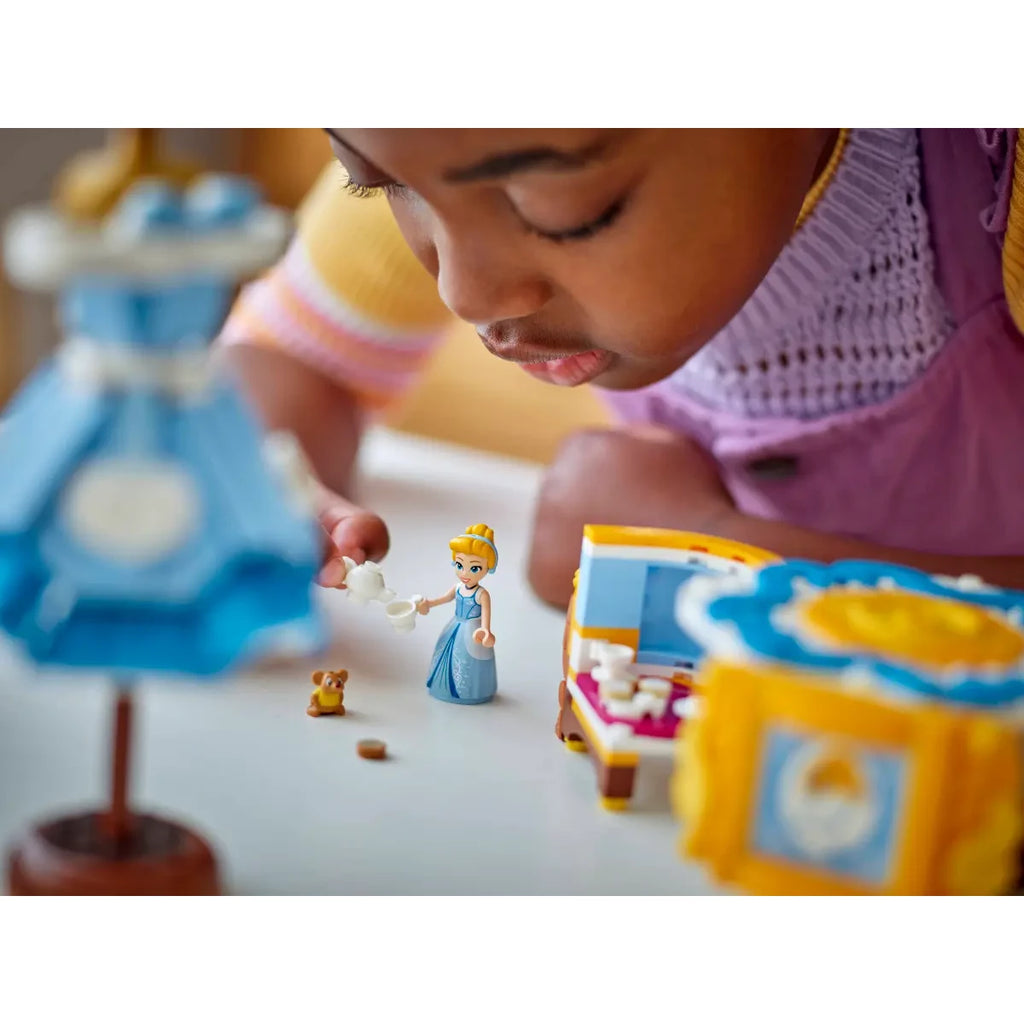 Child playing tea time with Cinderella, Gus and the accessories from LEGO Cinderella’s Dress 43266