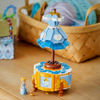 LEGO Cinderella’s Dress 43266 displayed on a wooden dresser with the Cinderella minidoll and Gus mouse