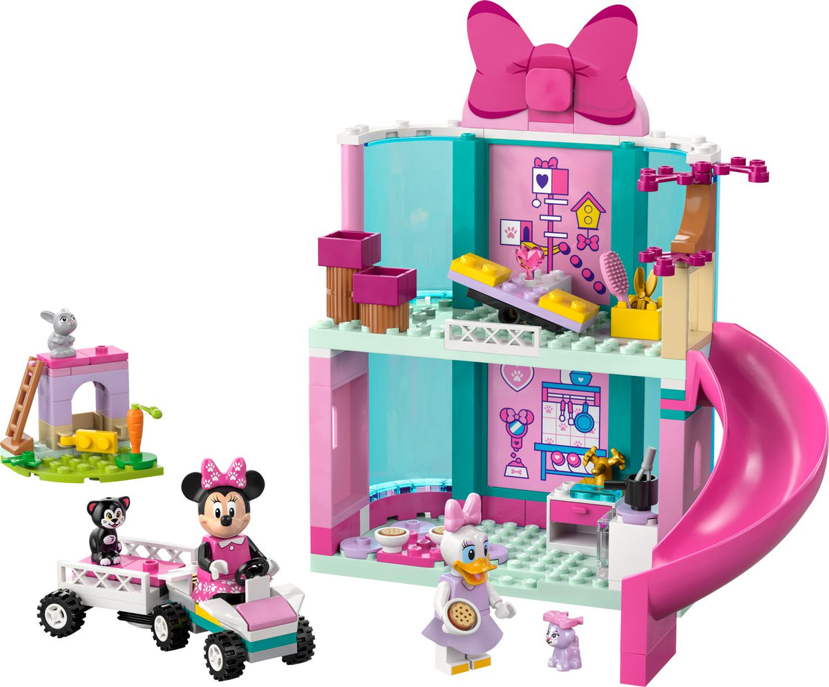 Official LEGO product image of the built Minnie’s Pet Hotel set 43274 with Minnie Mouse, Daisy Duck, pets, slide, car and trailer.