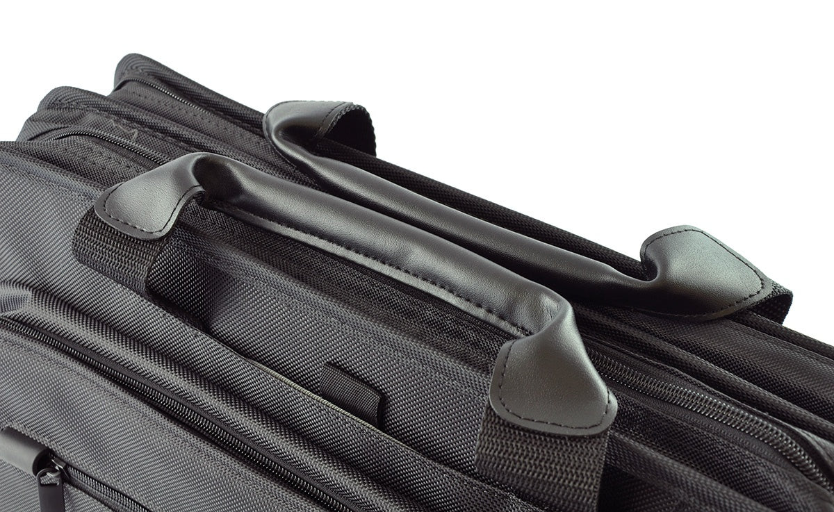 Close-up of a black suitcase with handles on a white background