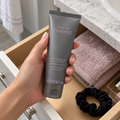 Taking a closed Mary Kay TimeWise Night Cream tube from a bathroom drawer