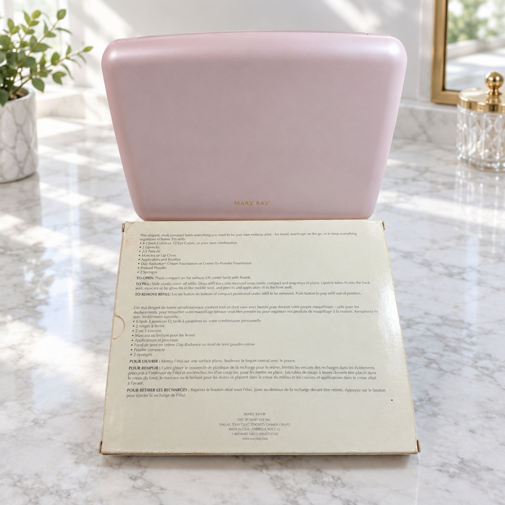 Closed pink Mary Kay Color Palette 5928 and original cream box on a bright marble vanity