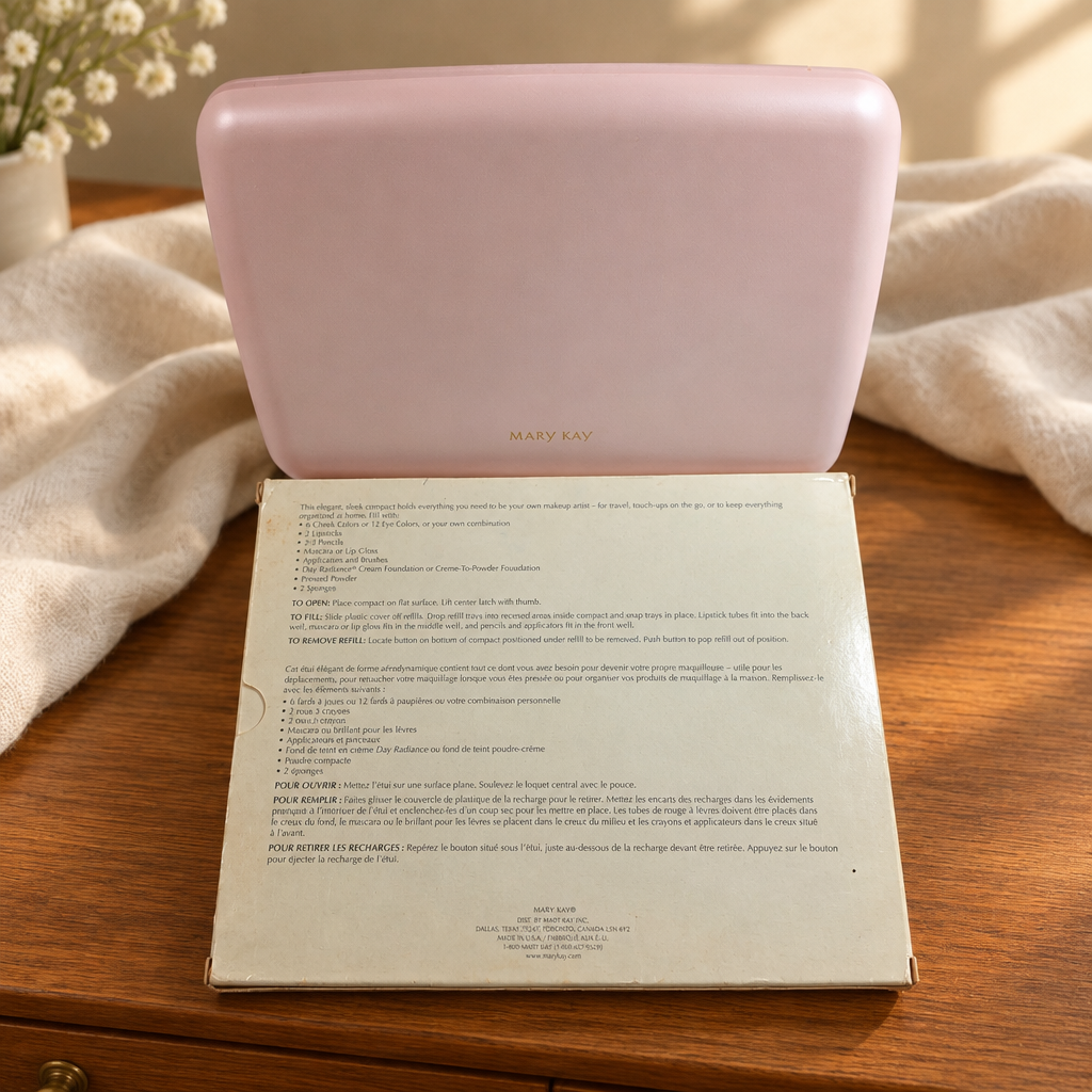 Pink Mary Kay Color Palette 5928 closed beside its original box on a warm wood dresser with cream fabric