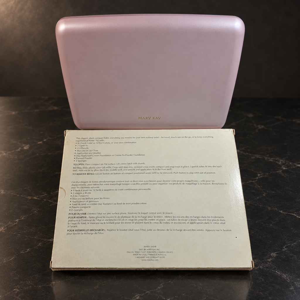 Closed Mary Kay Color Palette 5928 with gold lettering and original box on a dark stone table