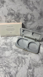 Original photograph: Mary Kay Foundation Compact 869100 with empty D-shaped refill well, mirror and sponge compartment beside its box
