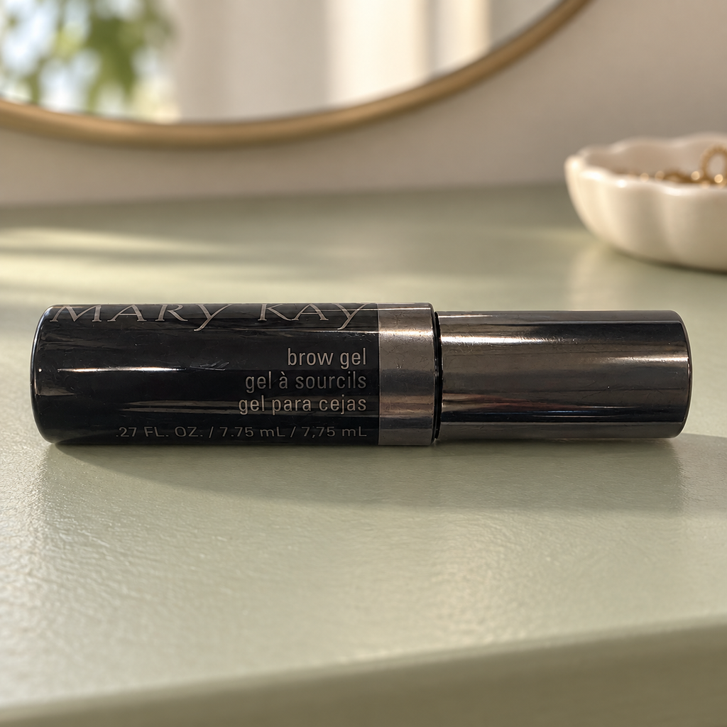 Mary Kay Brow Gel black tube on a sage dressing table with a mirror in the background