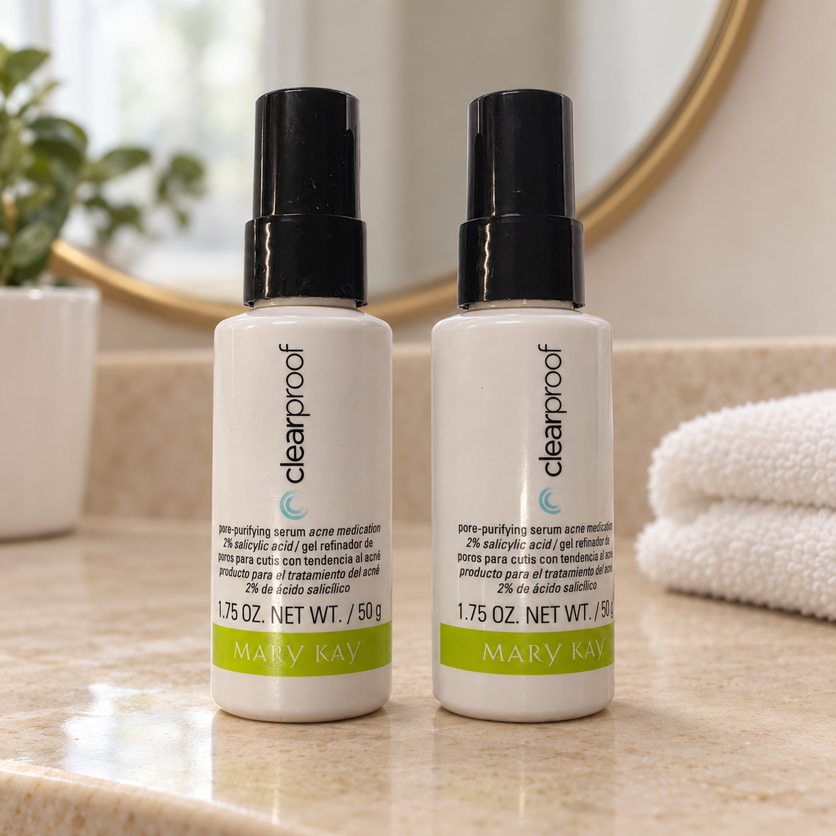 Styled lifestyle image of two Mary Kay Clear Proof Pore-Purifying Serum 1.75 oz bottles in a mirror vanity setting; props not included